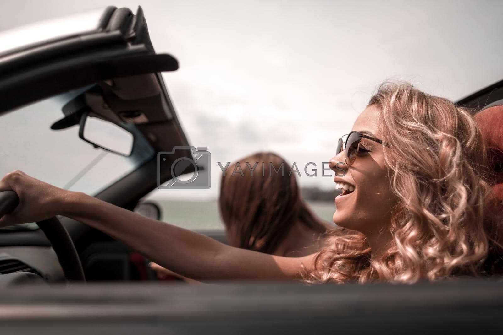 Royalty free image of close up. fashionable blonde driving a convertible by asdf