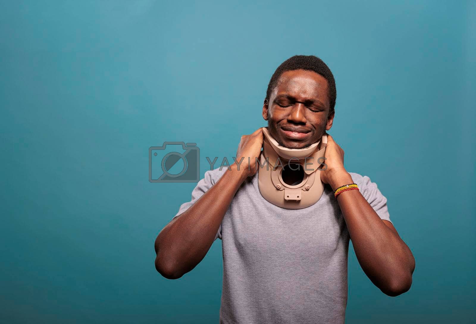 Royalty free image of Emotional guy wearing cervical collar to cure physical injury by DCStudio
