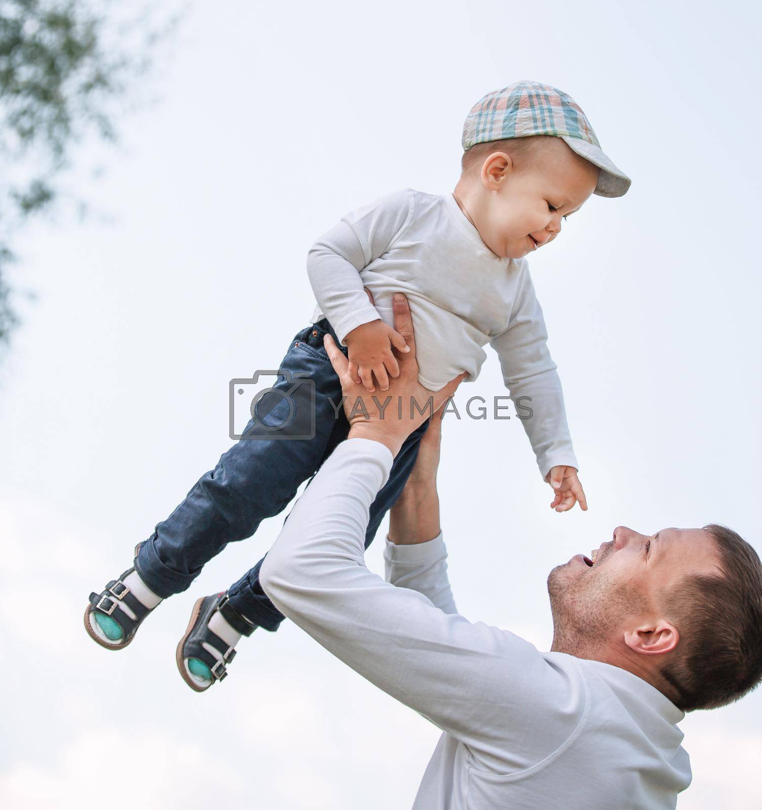 father and son on a background of blue sky. the concept of fatherhood