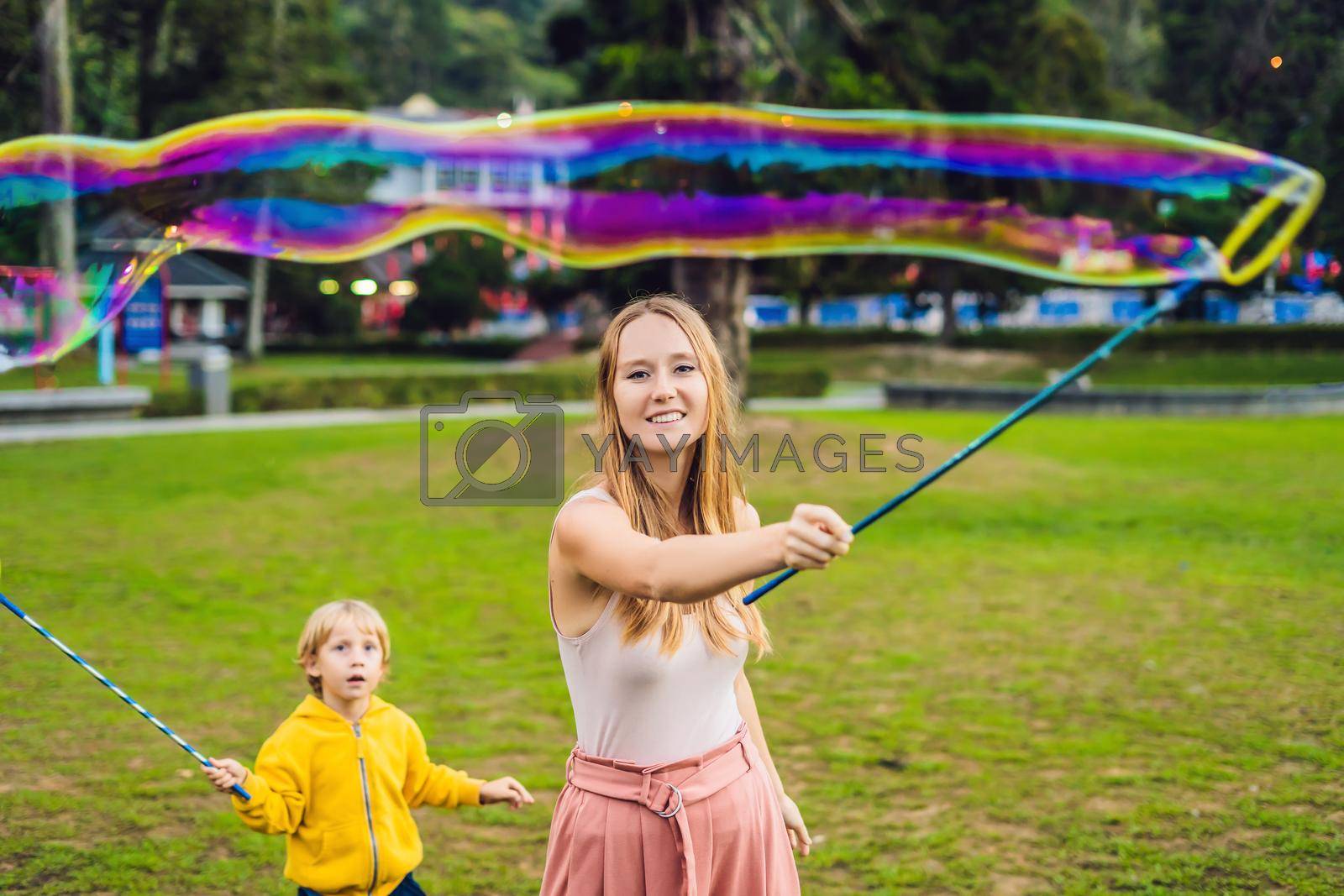Royalty free image of Happy carefree young woman blowing soap bubbles by galitskaya