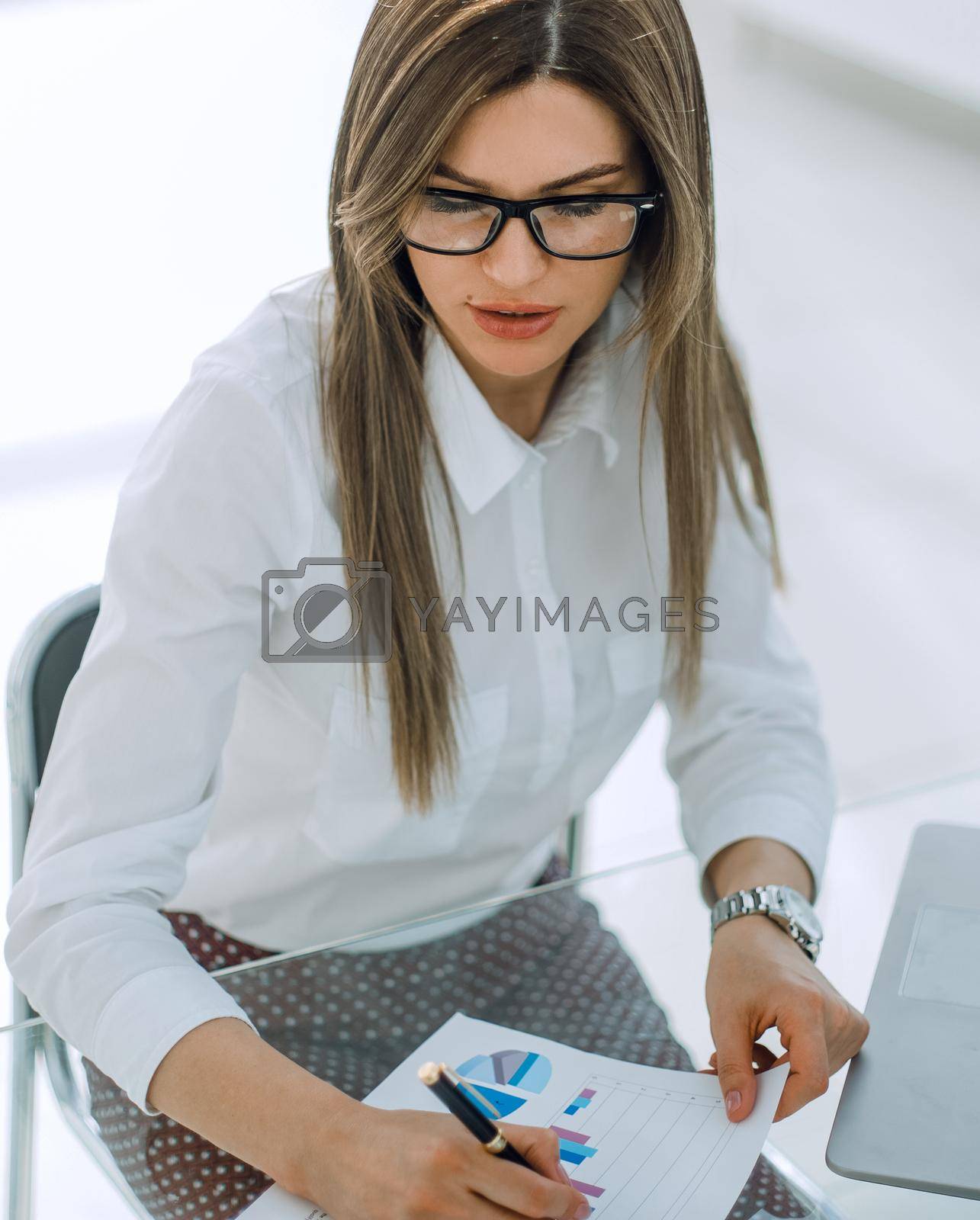 Royalty free image of business woman checking financial documents. by asdf