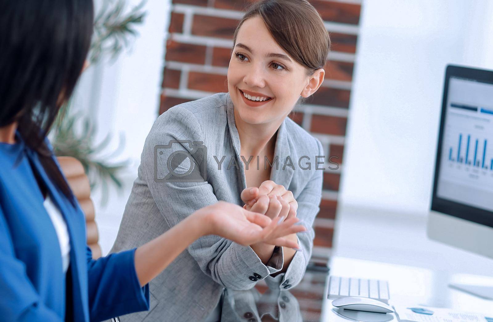 Royalty free image of Beautiful girls working together in the office by asdf
