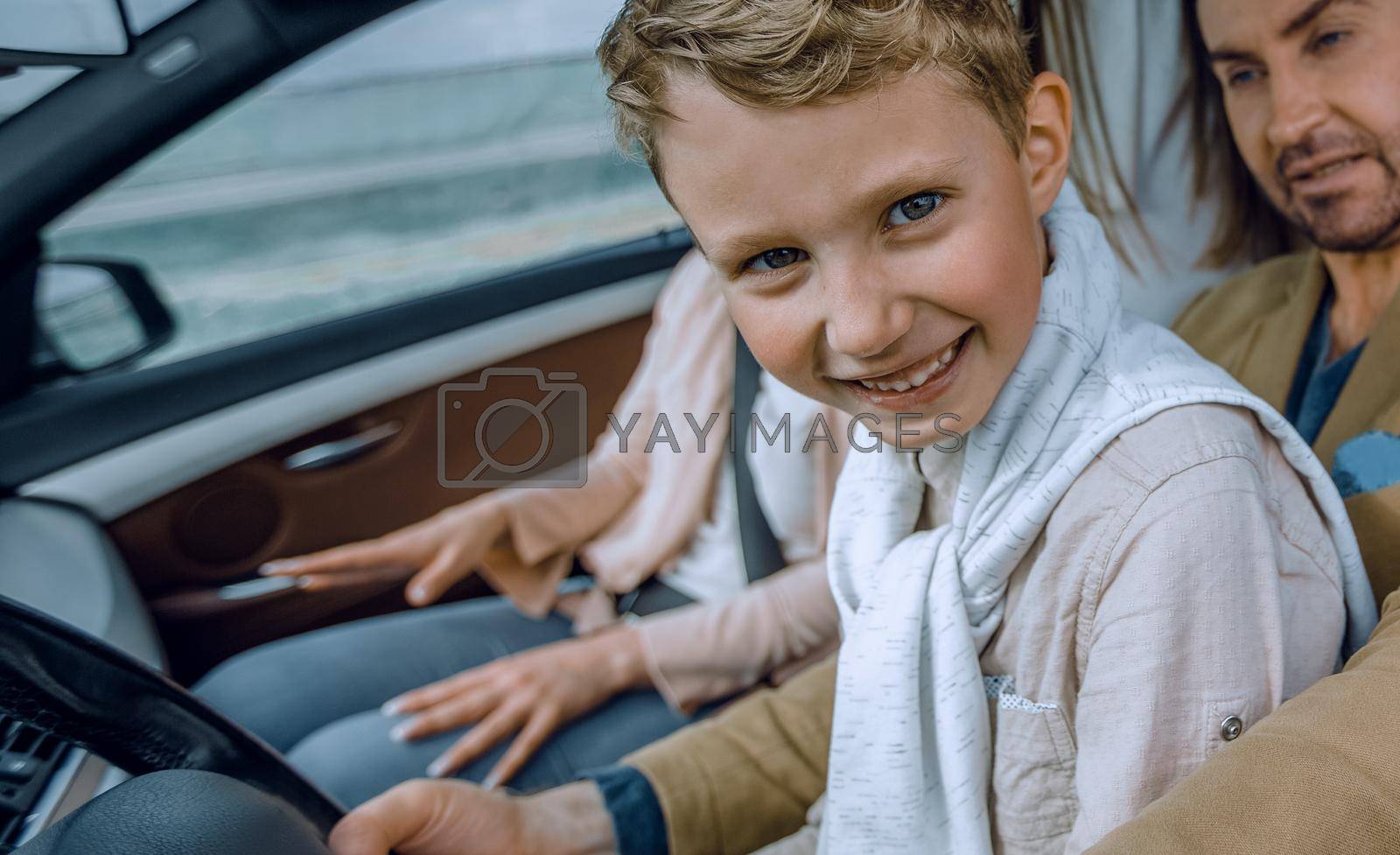 Royalty free image of father and son driving a car by asdf