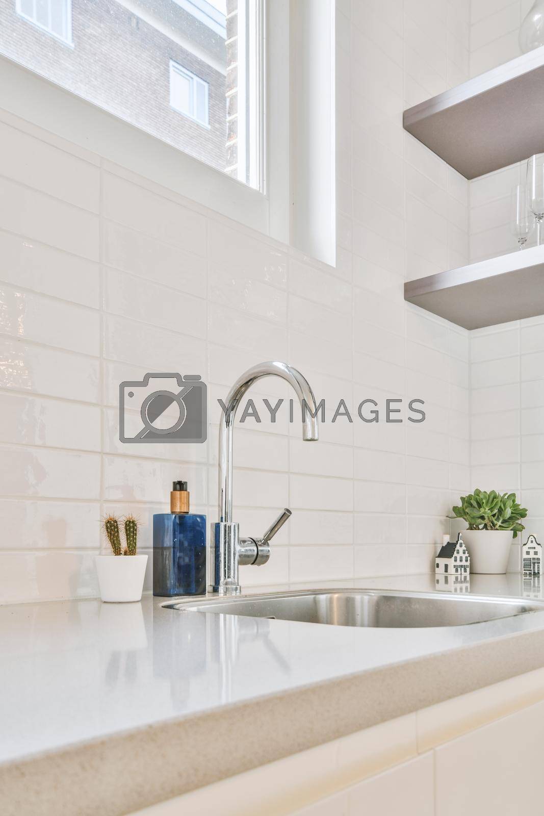 Royalty free image of Kitchen faucet close-up on a marble countertop by casamedia