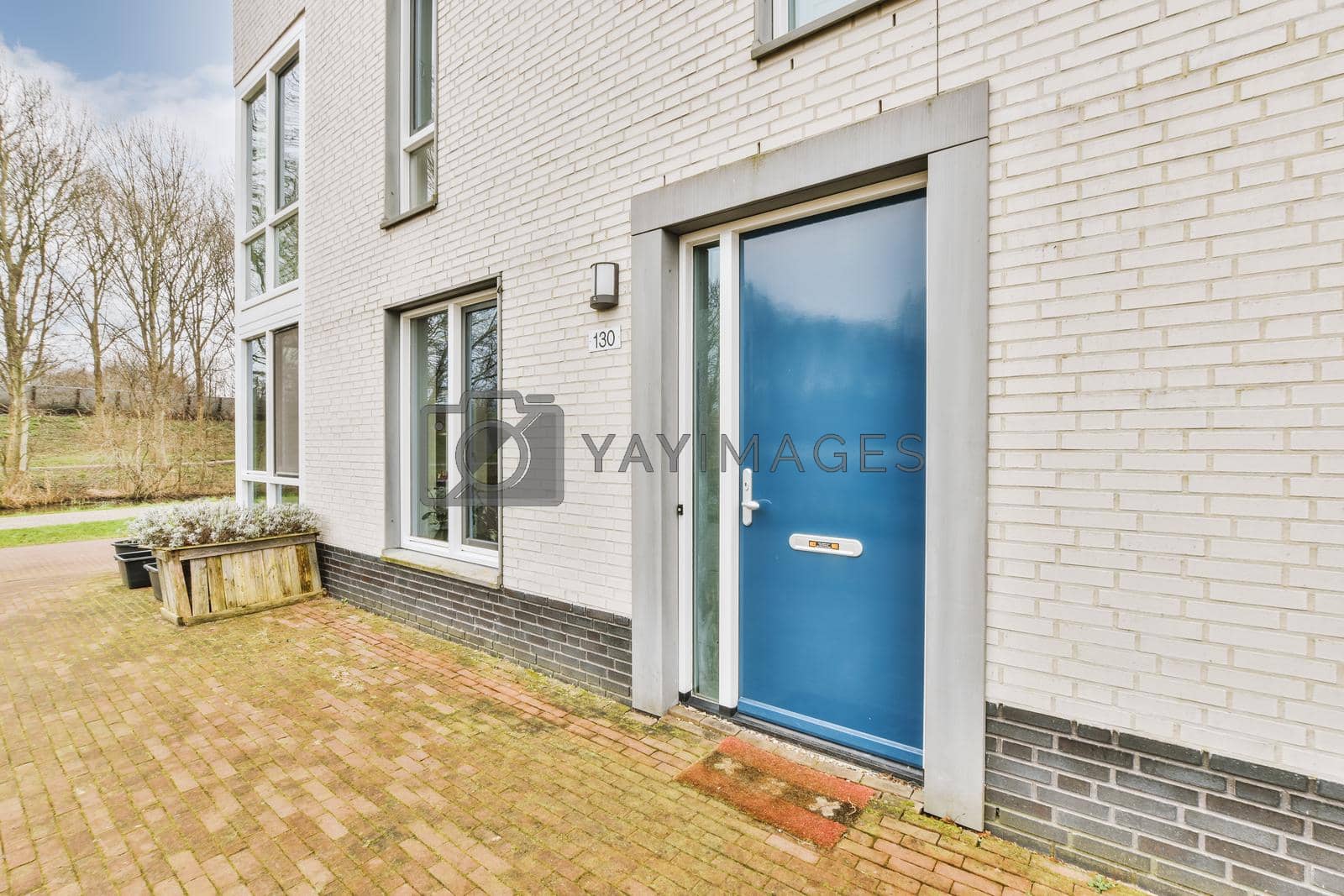 Royalty free image of The facade of a brick building with wooden door by casamedia