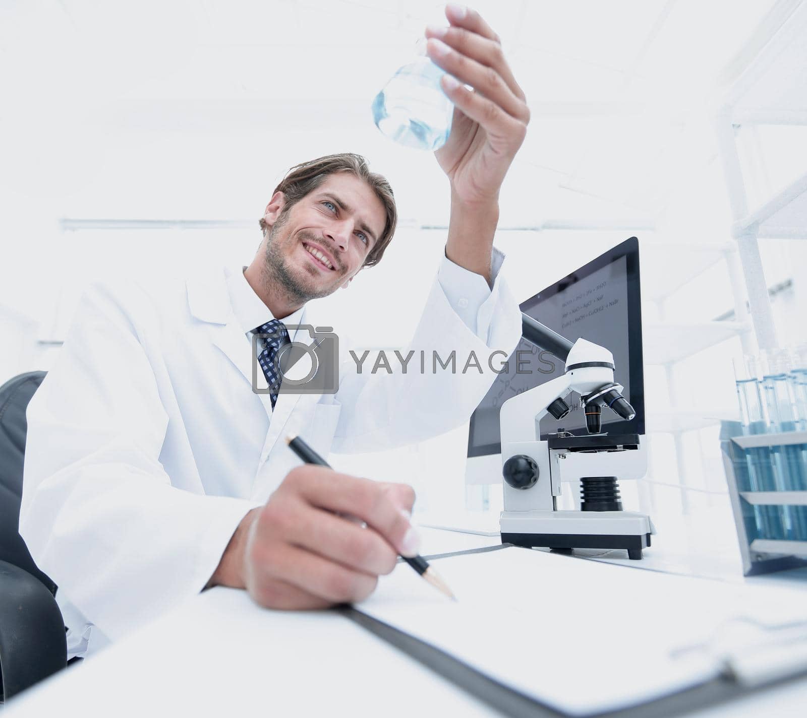 Royalty free image of scientist analyzing an experiment in a laboratory by asdf