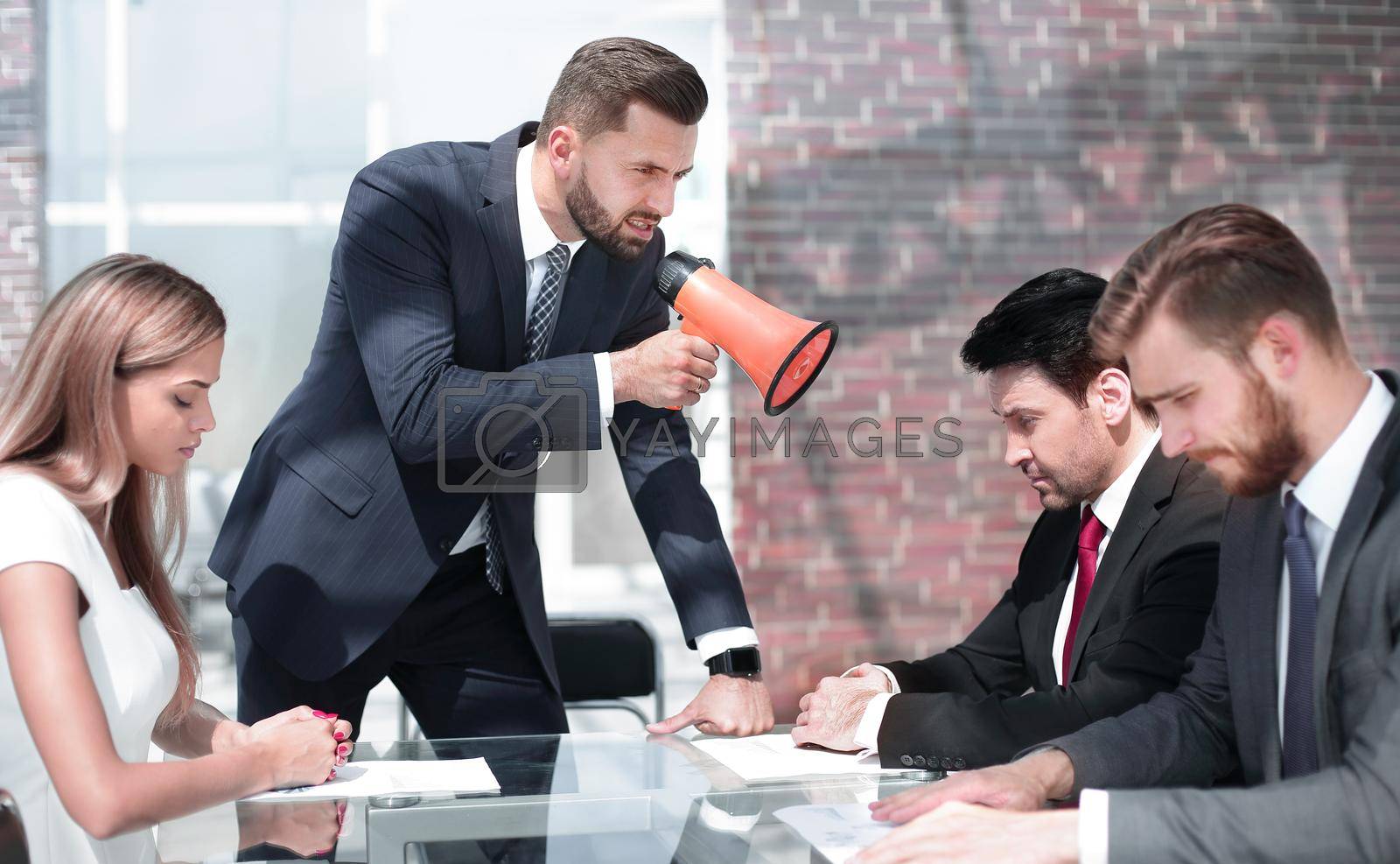 businessman yelling at his colleagues through a megaphone . management concept