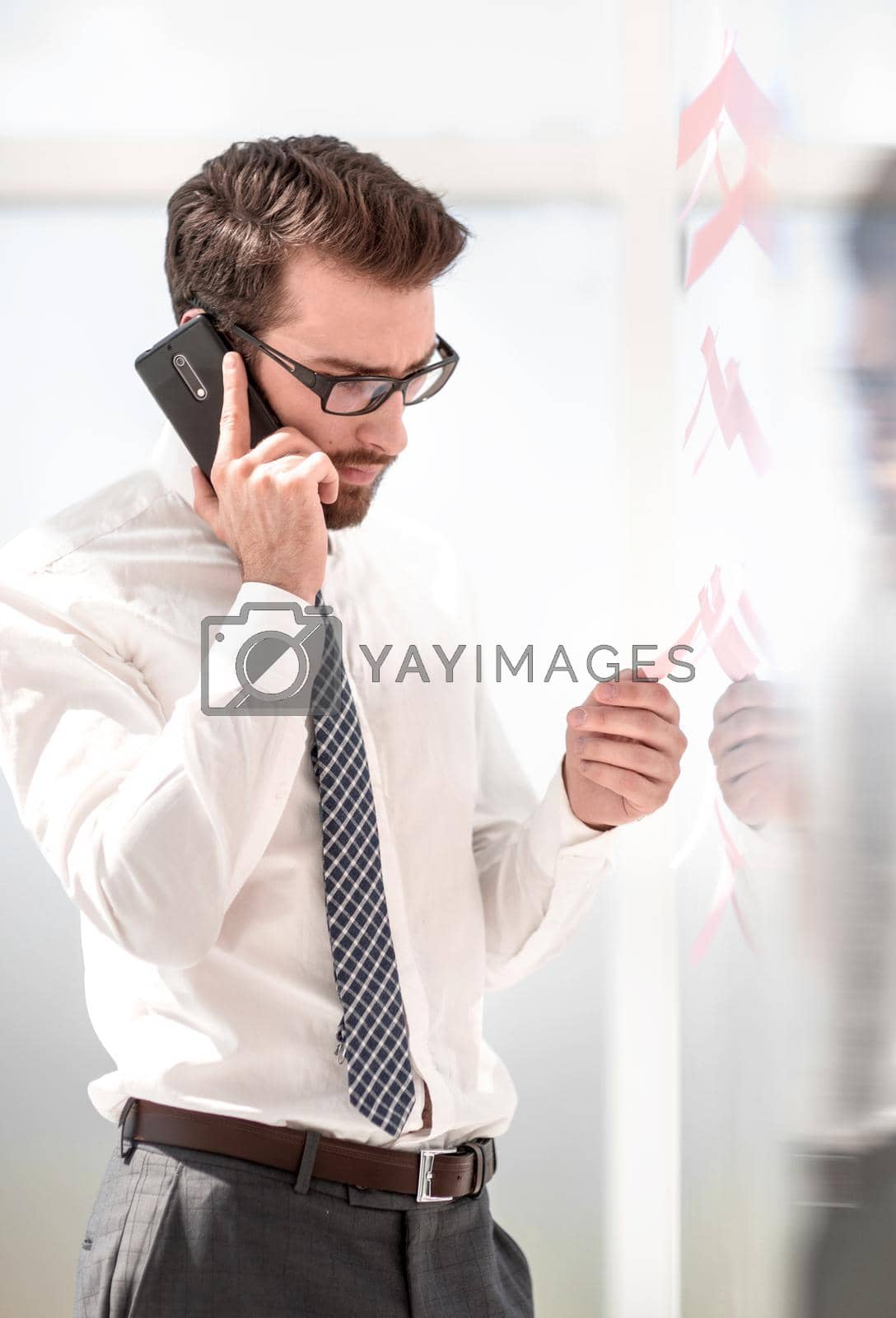 Royalty free image of serious businessman talking on smartphone. by asdf