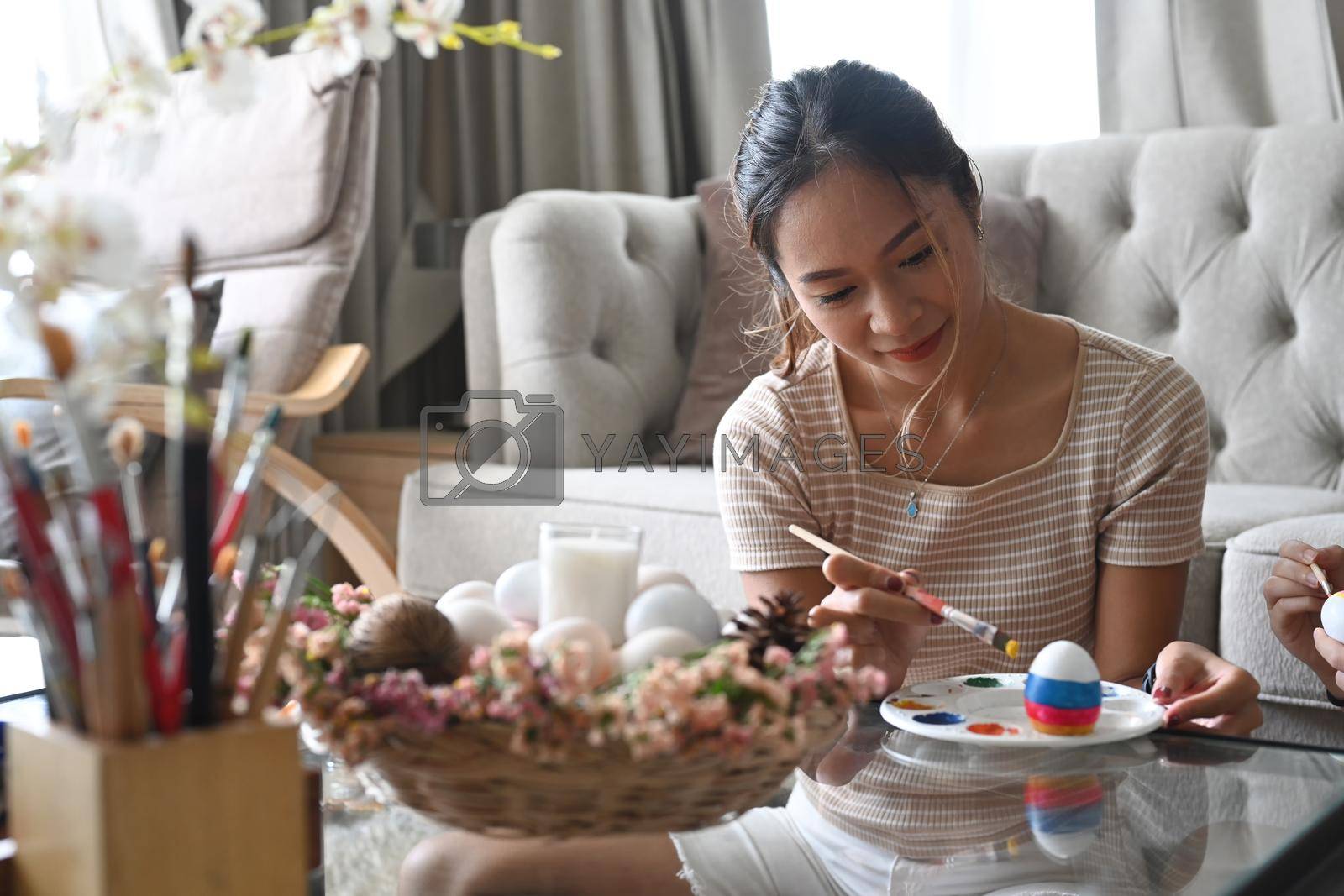 Attractive woman preparing for Easter celebration at home. Easter holidays concept.
