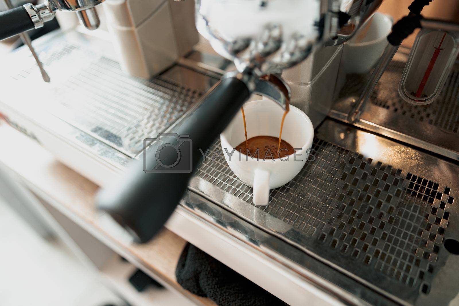 Royalty free image of Professional coffee machine brewing coffee in cafeteria by Yaroslav_astakhov