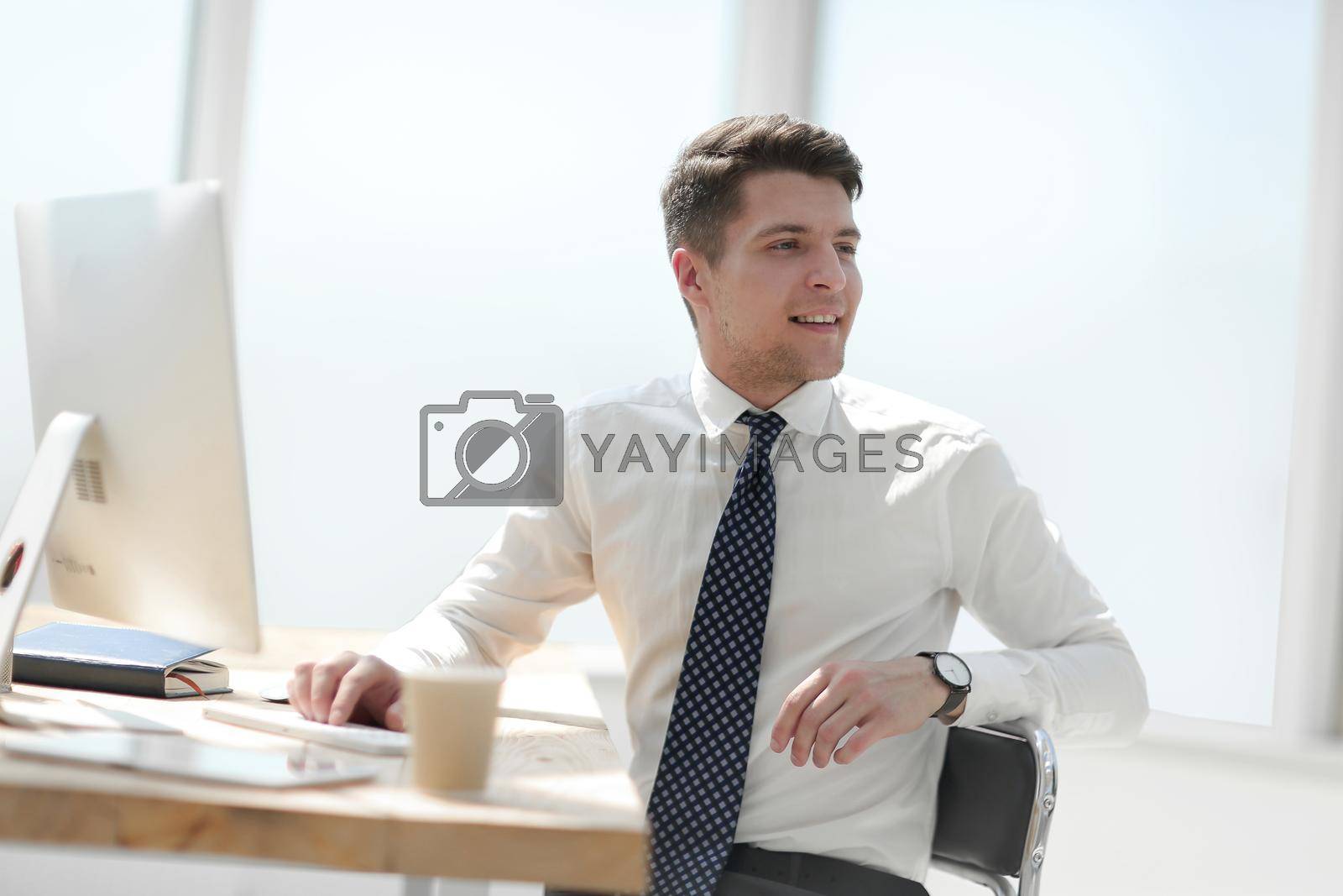 Royalty free image of young employee in the workplace in the office by asdf