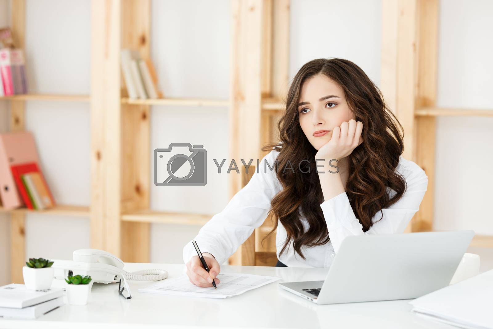 Royalty free image of Young pretty business woman with notebook and document in the bright modern office indoors by Benzoix
