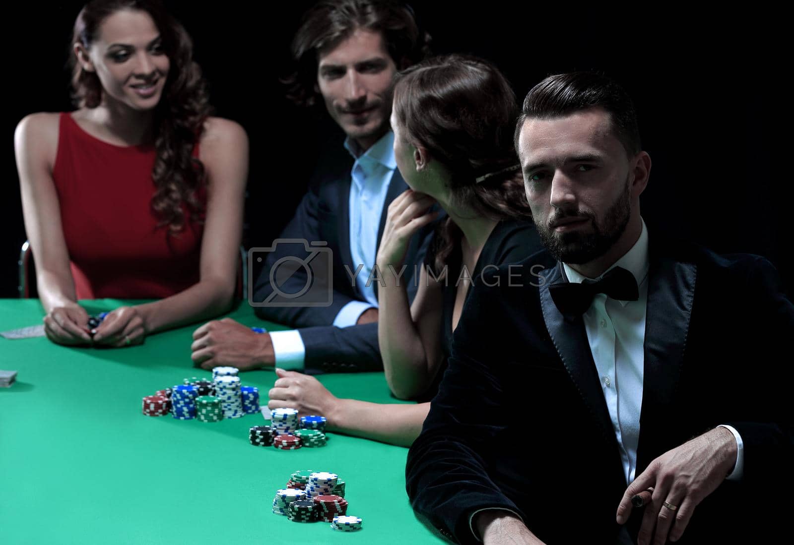 Royalty free image of Man with cigar looking up from poker game in casino by asdf