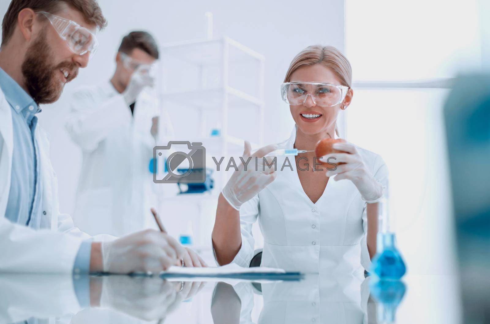 Royalty free image of Food quality control. a group of scientists testing the fruit by asdf