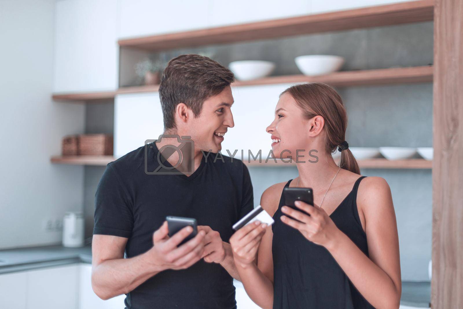 Royalty free image of young couple uses smartphone to order food at home by asdf
