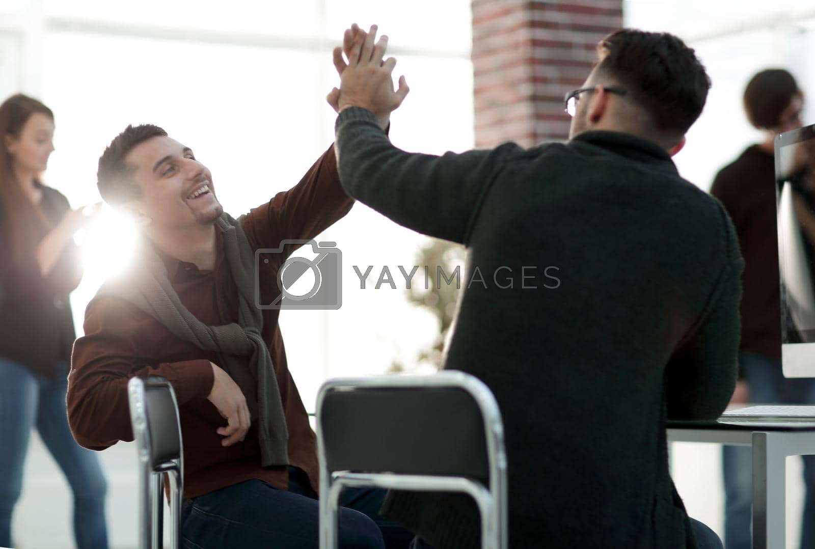 Royalty free image of business colleagues giving each other high five by asdf