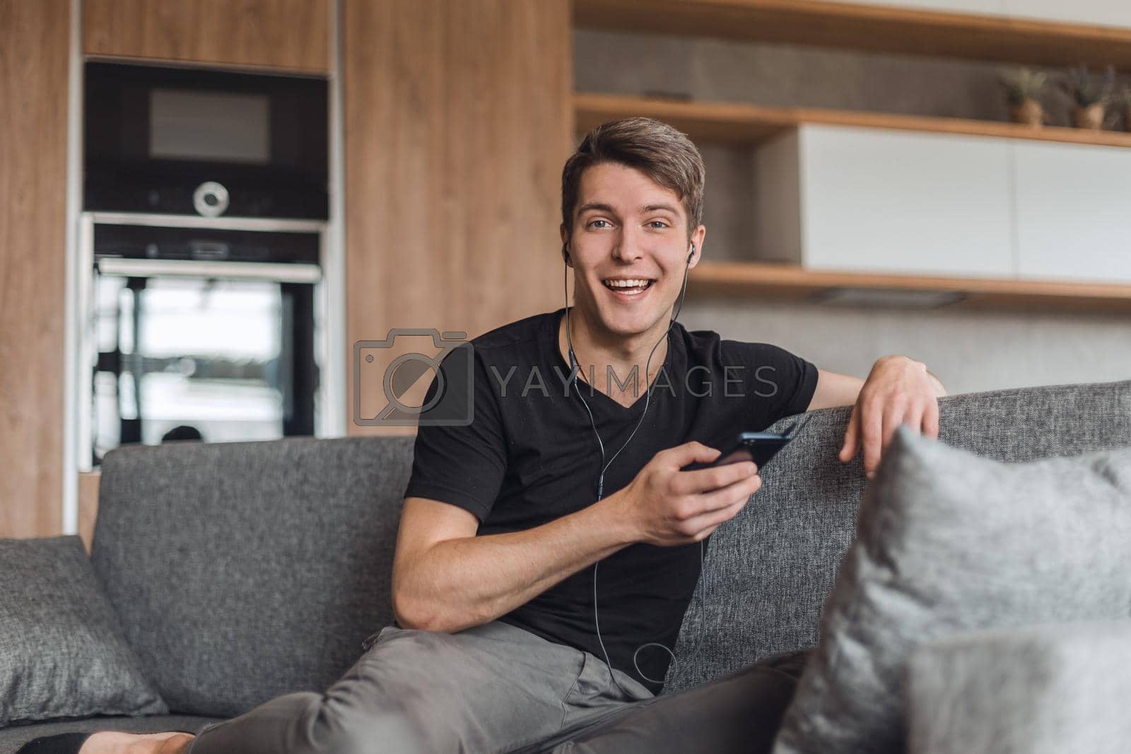 Royalty free image of happy guy listening to fun music through headphones by asdf