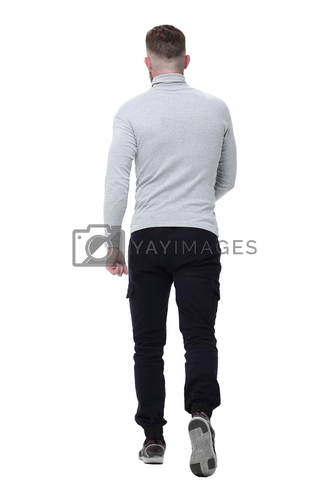 Royalty free image of rear view. a young man in a white pullover walks forward by asdf