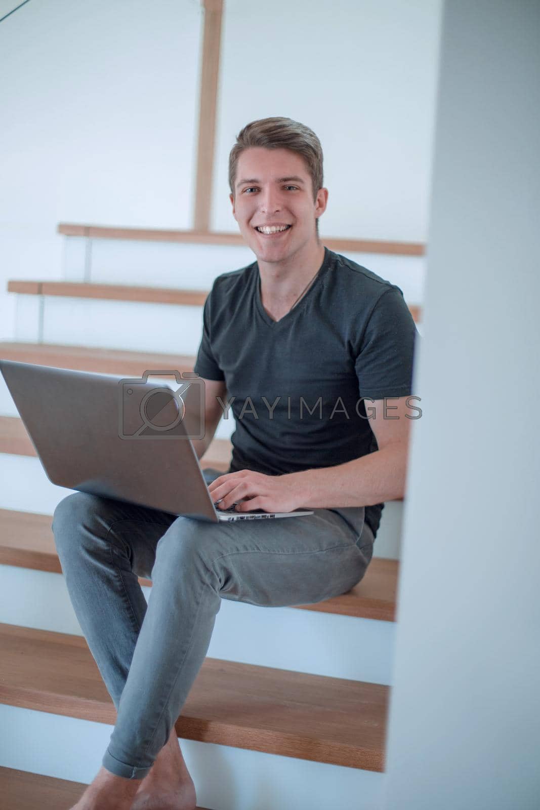 Royalty free image of cheerful young man talking by video link using laptop by asdf