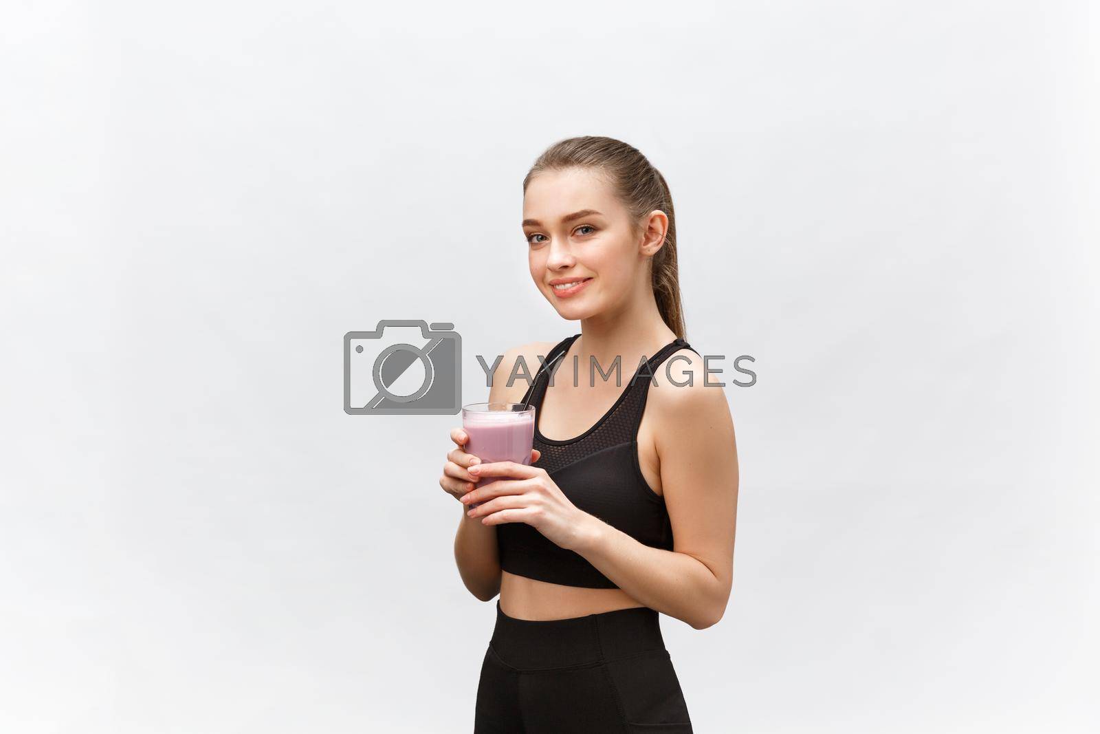 Royalty free image of young happy woman with healthy diet shake drinking for sport and fitness. by Benzoix