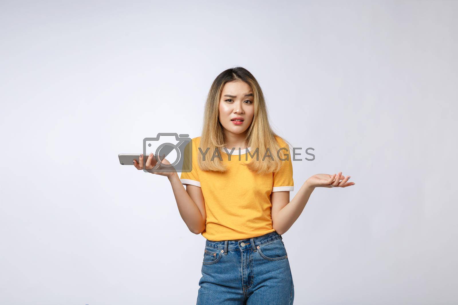 Royalty free image of Unhappy Asian girl on the phone , Angry Asian woman talking phone with her boyfriend, isolated on white background. by Benzoix