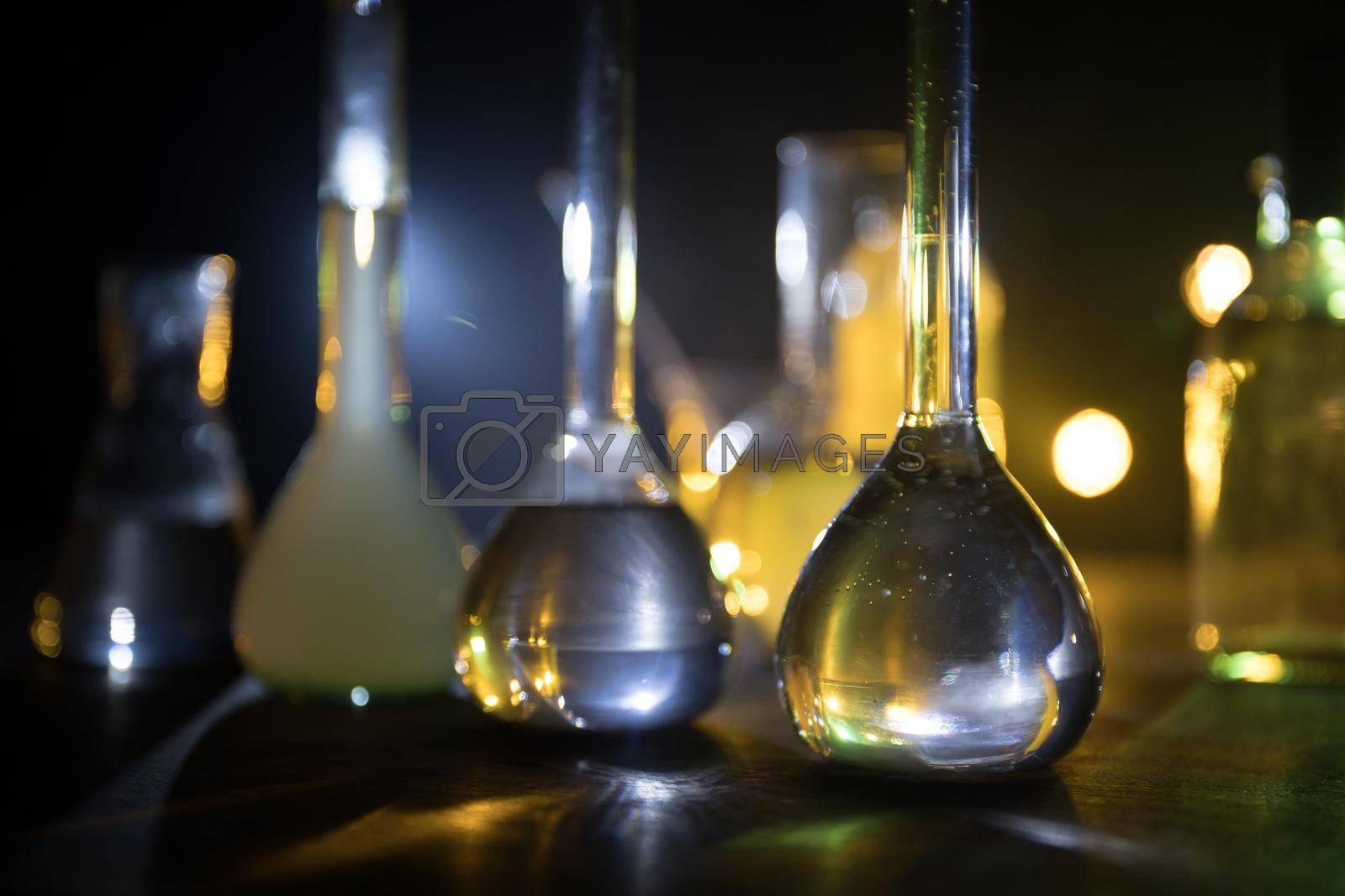 Royalty free image of Test glass flask with solution in research laboratory. Science and medical background. Laboratory test tubes on dark toned background , science research equipment concept by Zeferli