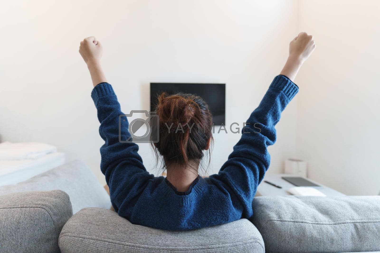 Royalty free image of Excited, happy modern woman watch world cup football match, championship on the couch at home. Sport, TV, having fun. by itchaznong