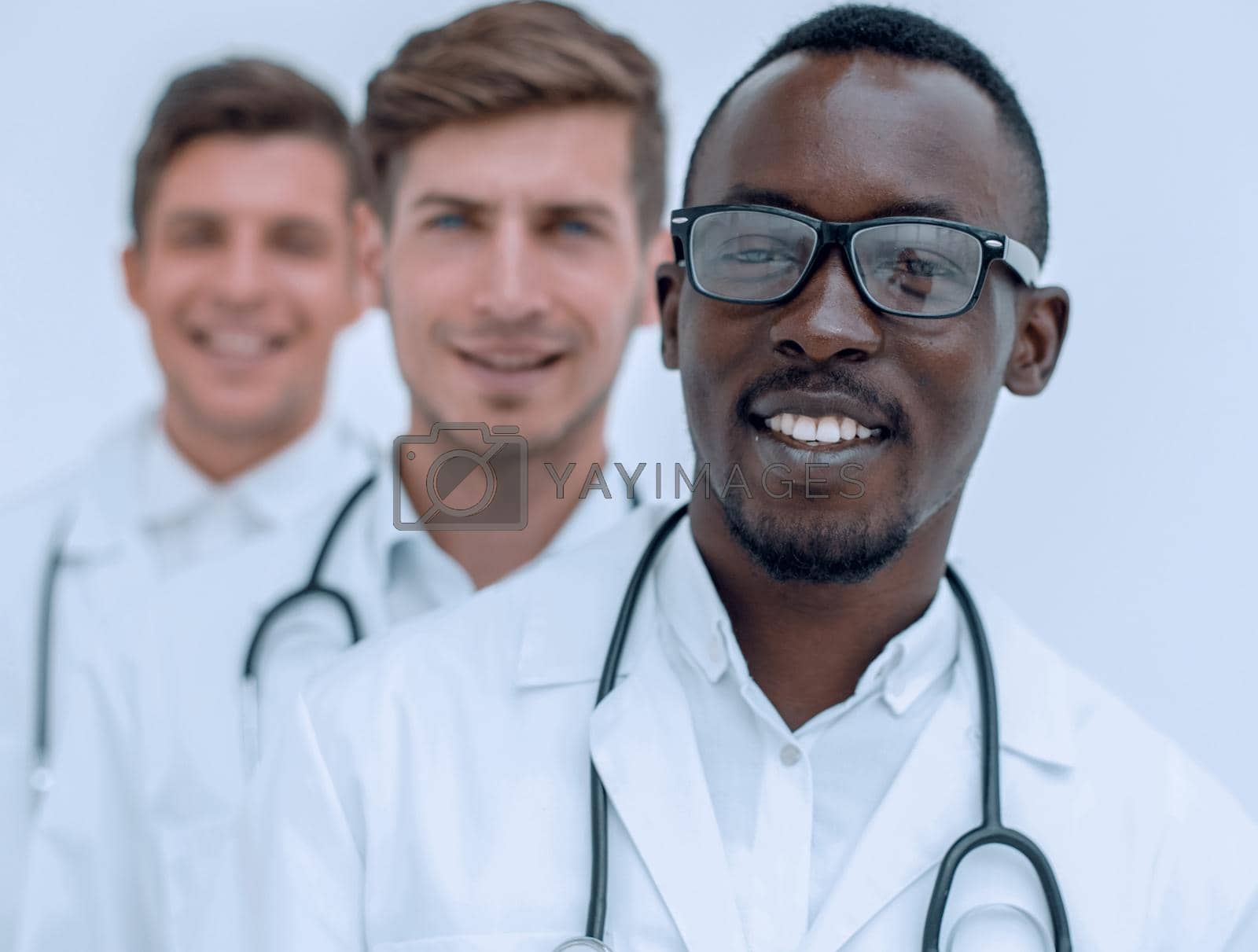 Royalty free image of group of multi-racial doctors standing in a row by asdf