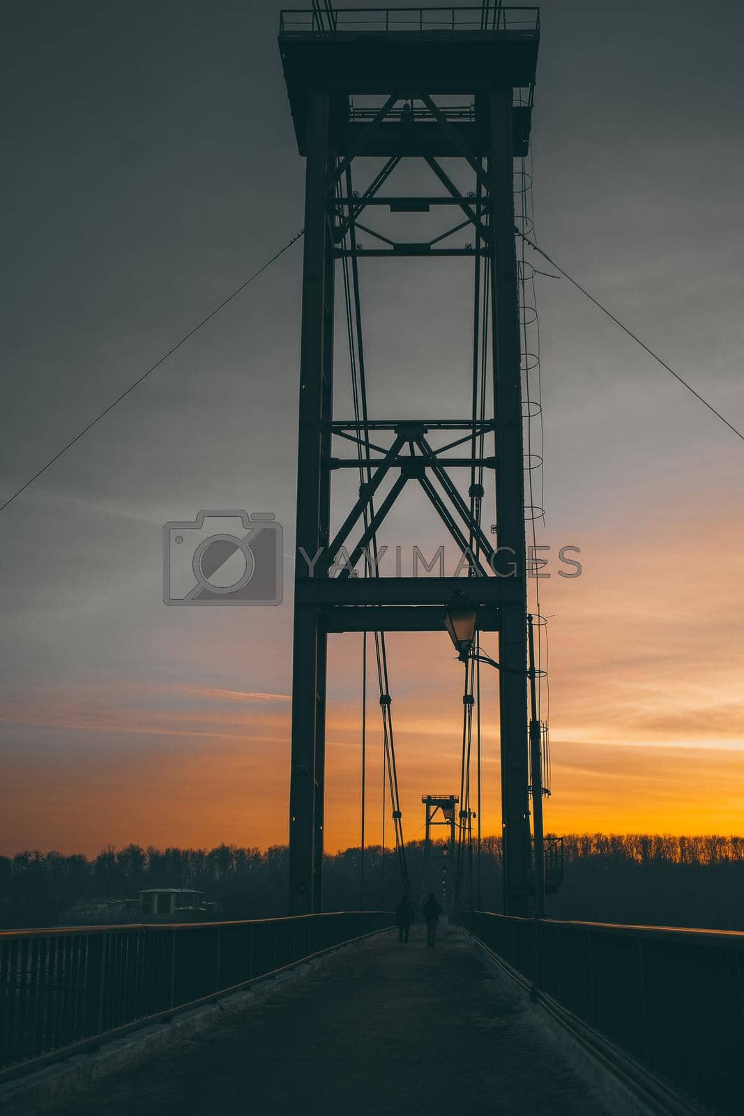 Royalty free image of Landscape of a pedestrian bridge in the evening at sunset. by N_Design
