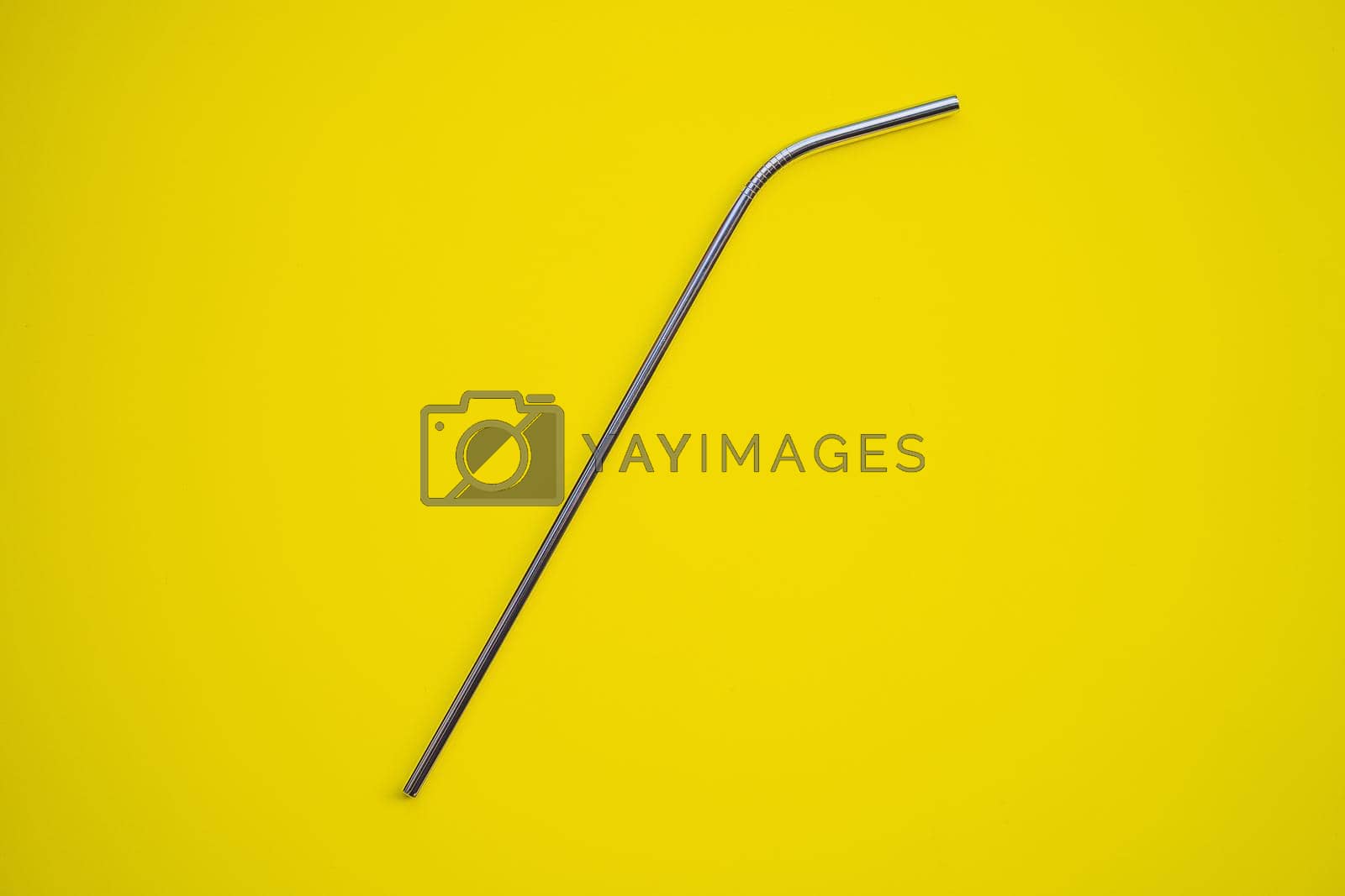 Royalty free image of Steel drinking straws on a yellow background. Zero waste concept by galitskaya
