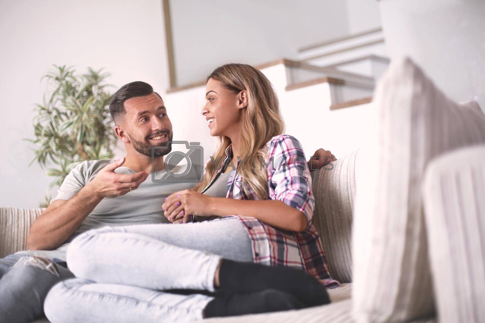 Royalty free image of loving couple relaxing on the couch on a free evening by asdf