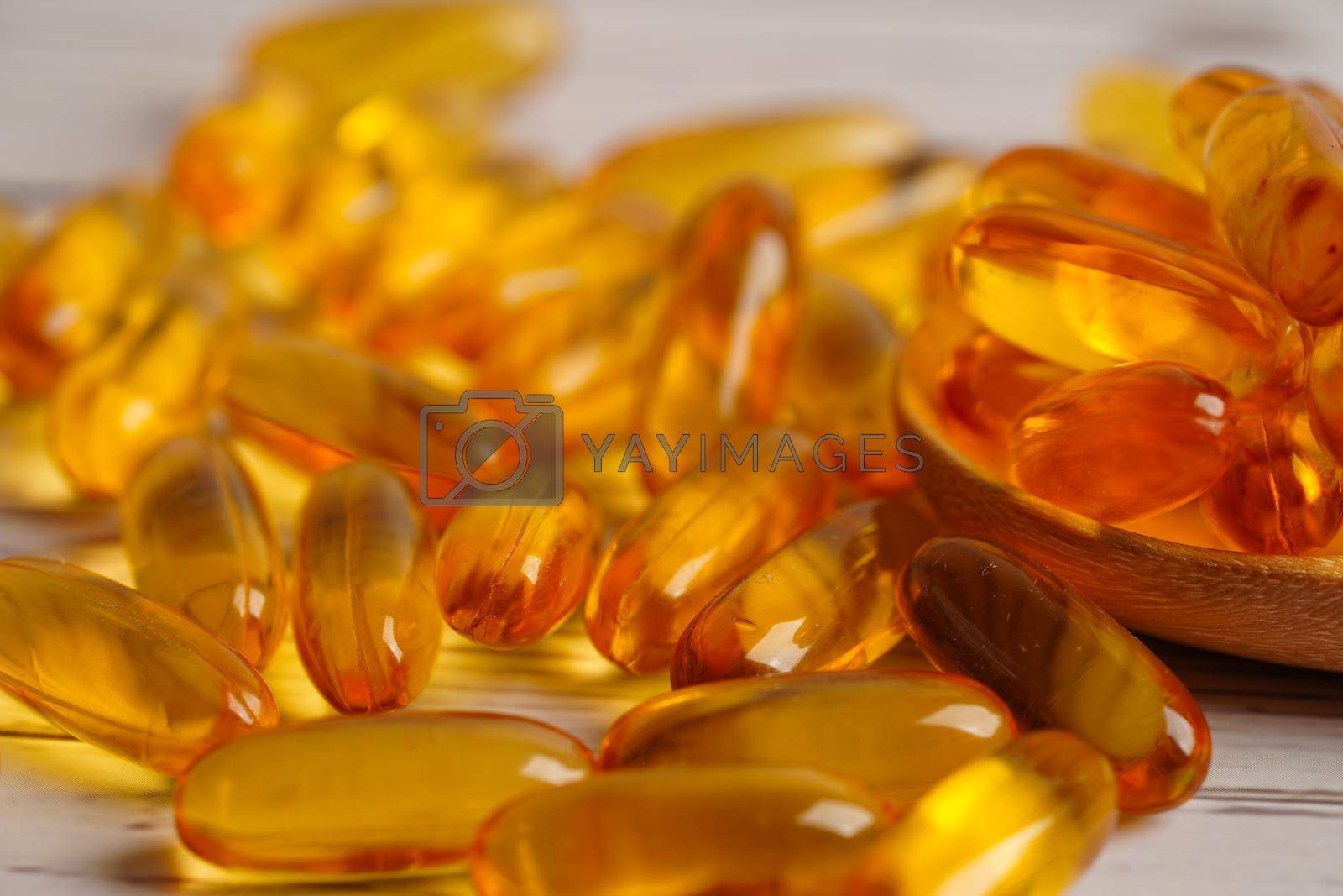 Royalty free image of Fish oil or Cod liver oil gel in capsules with omega 3 vitamins, supplementary healthy food  by sweettomato