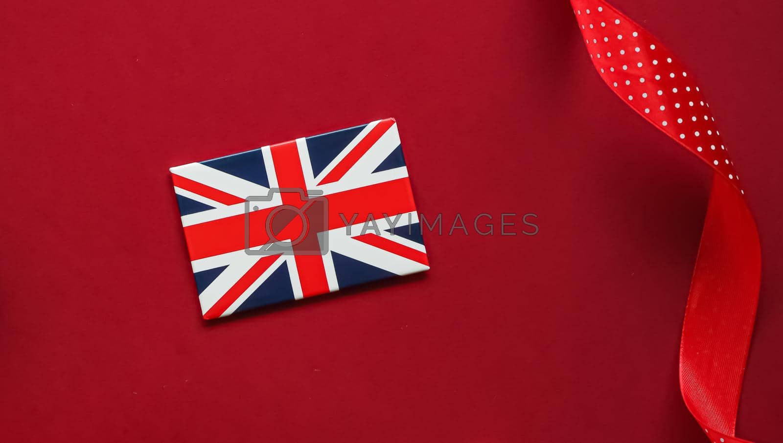 Royalty free image of Union Jack flag of Great Britain on red background, Queen's Platinum Jubilee and holiday celebration by Anneleven