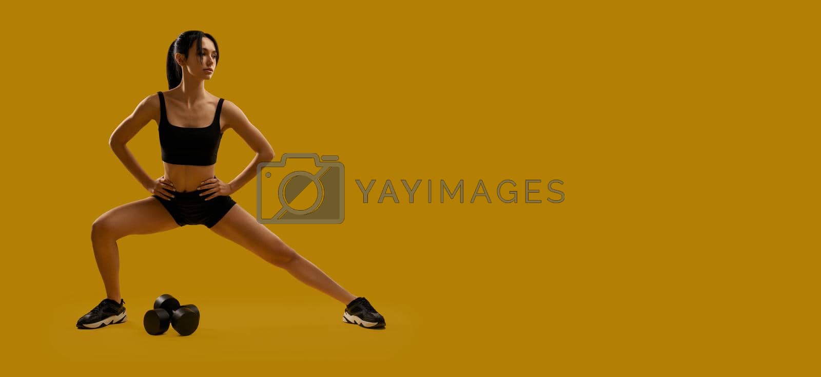Royalty free image of Sporty, slim emale exercising, working out, training. by SerhiiBobyk