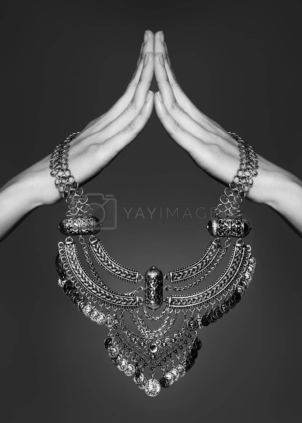 Silver Necklace Jewelry in Woman Hands. Beautiful Fashion Accessories. Luxury Gift, Tibet Silver Jewellery on Grey Background. Black and White