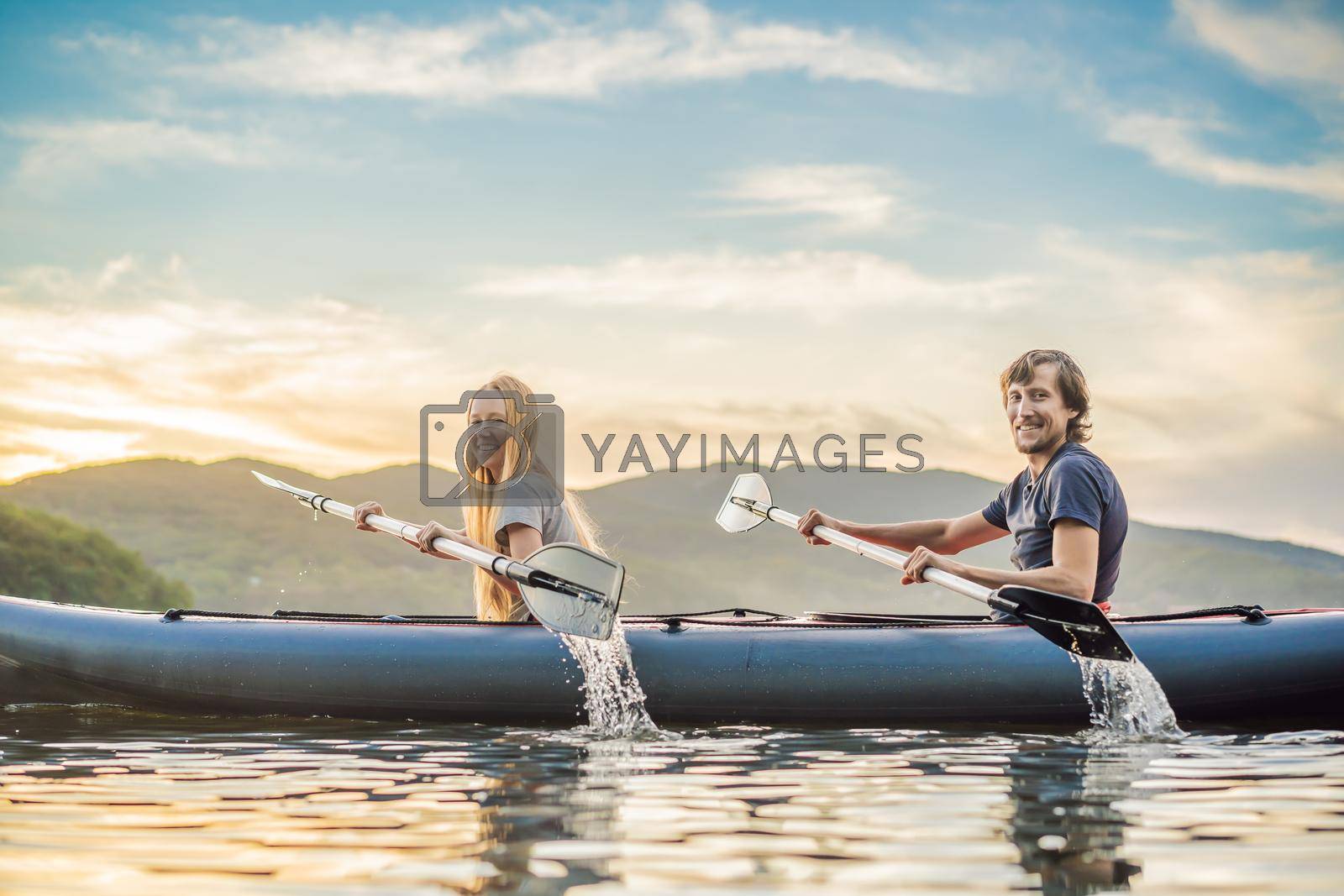 Royalty free image of Man and woman swims on kayak in the sea on background of island. Kayaking concept.Kayaking concept with family of father mother at sea by galitskaya