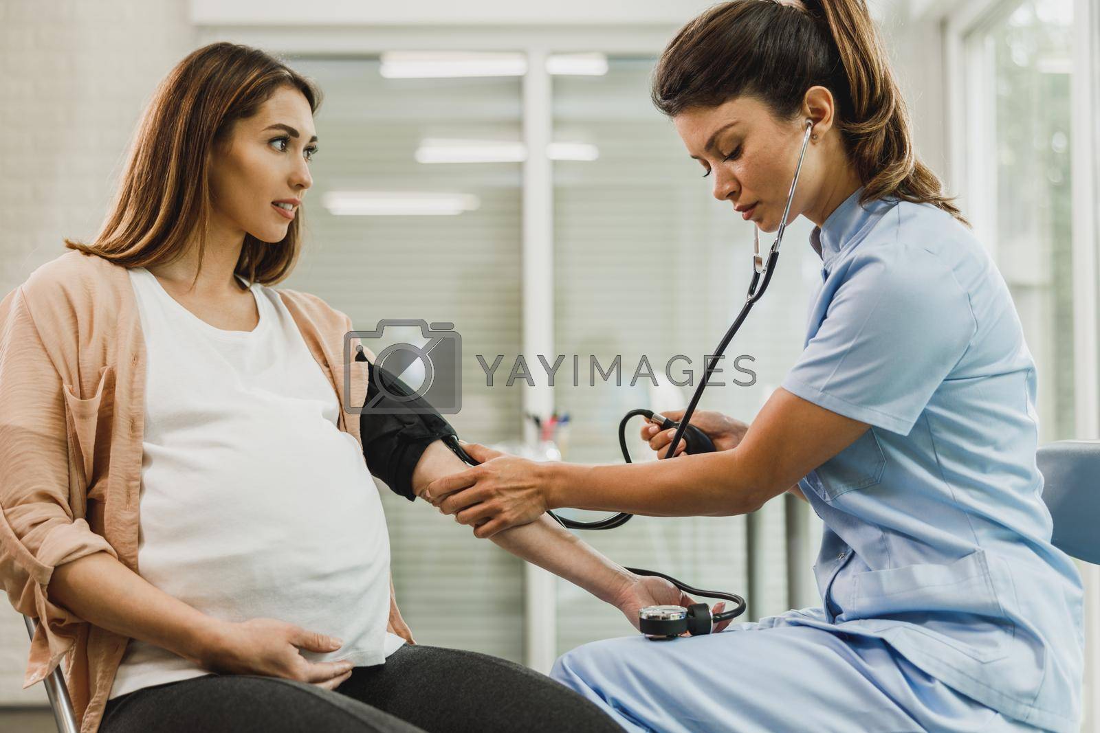 Royalty free image of Gynecology Nurse Checking The Blood Pressure Of Pregnant Woman by MilanMarkovic78