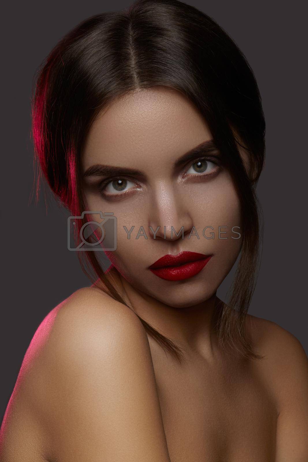 Royalty free image of Beautiful model with fashion make-up. Close-up portrait sexy woman with glamour lip gloss makeup and bright eye shadows. by MarinaFrost