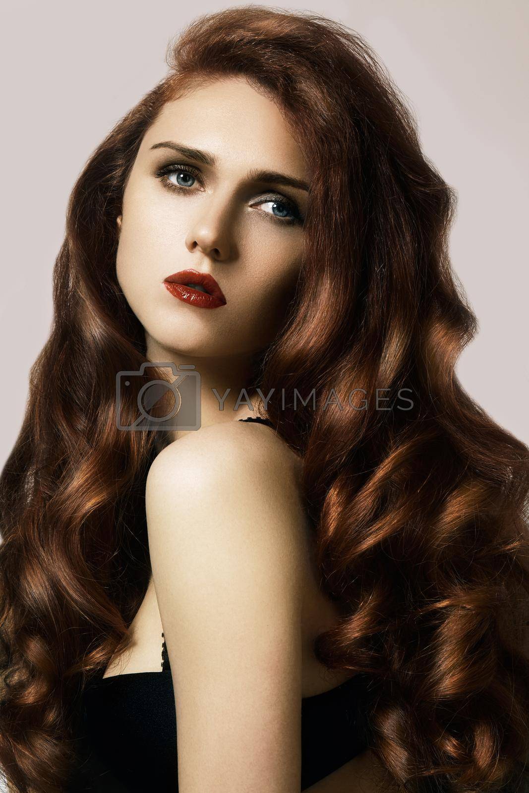 Royalty free image of Beautiful ginger young woman with luxury hair style and fashion gloss makeup. Beauty closeup sexy model with red hair by MarinaFrost