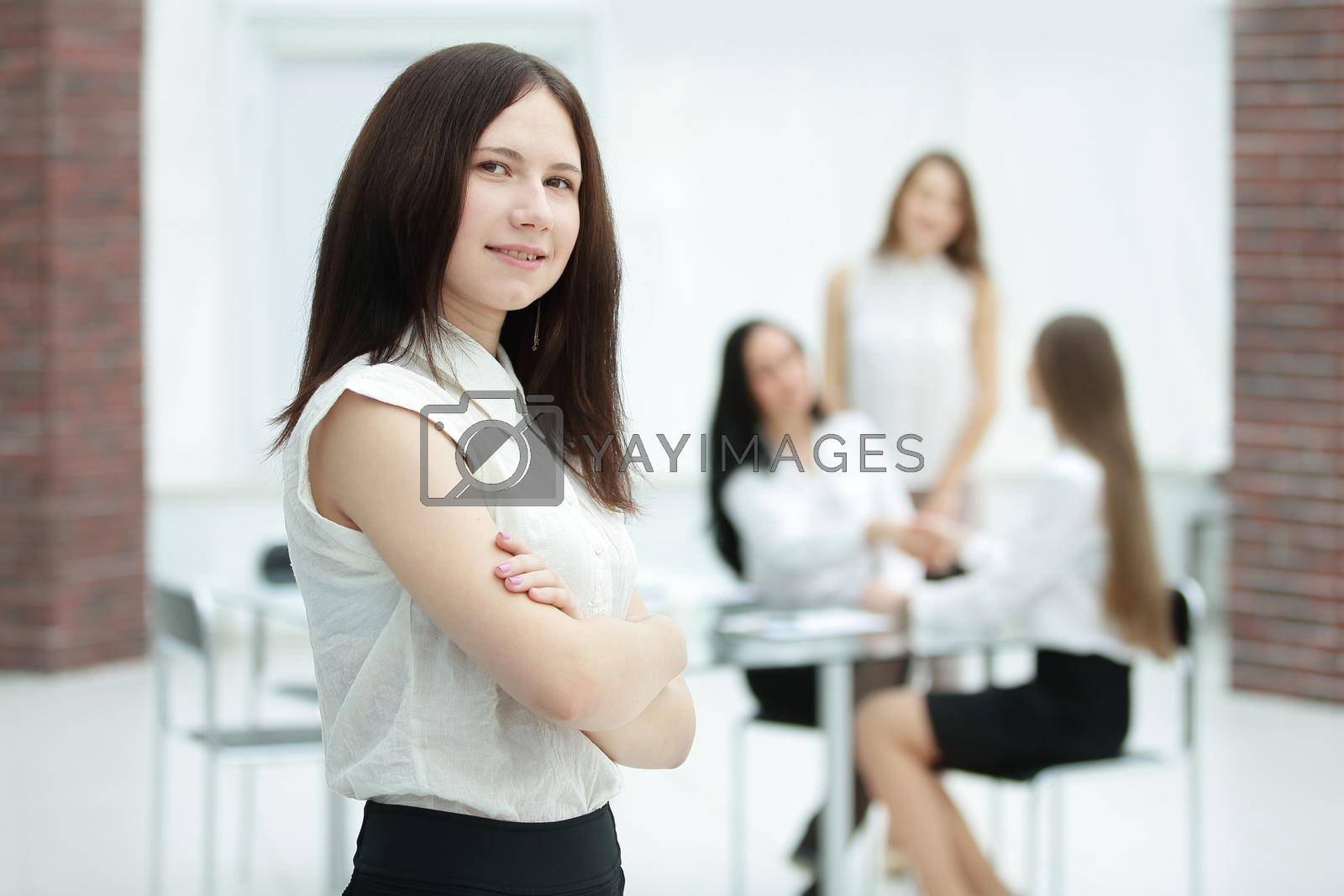 Royalty free image of young employee on blurred office background.photo with copy space by SmartPhotoLab