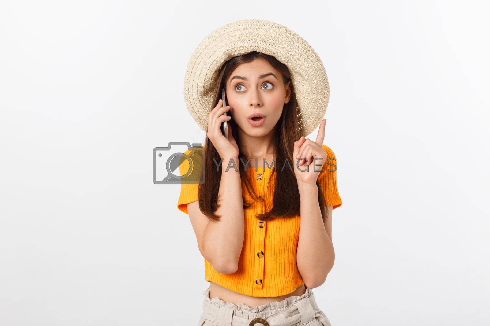 Royalty free image of Picture of surprised voyage girl looking shock while holding phone in hands isolated over grey background by Benzoix
