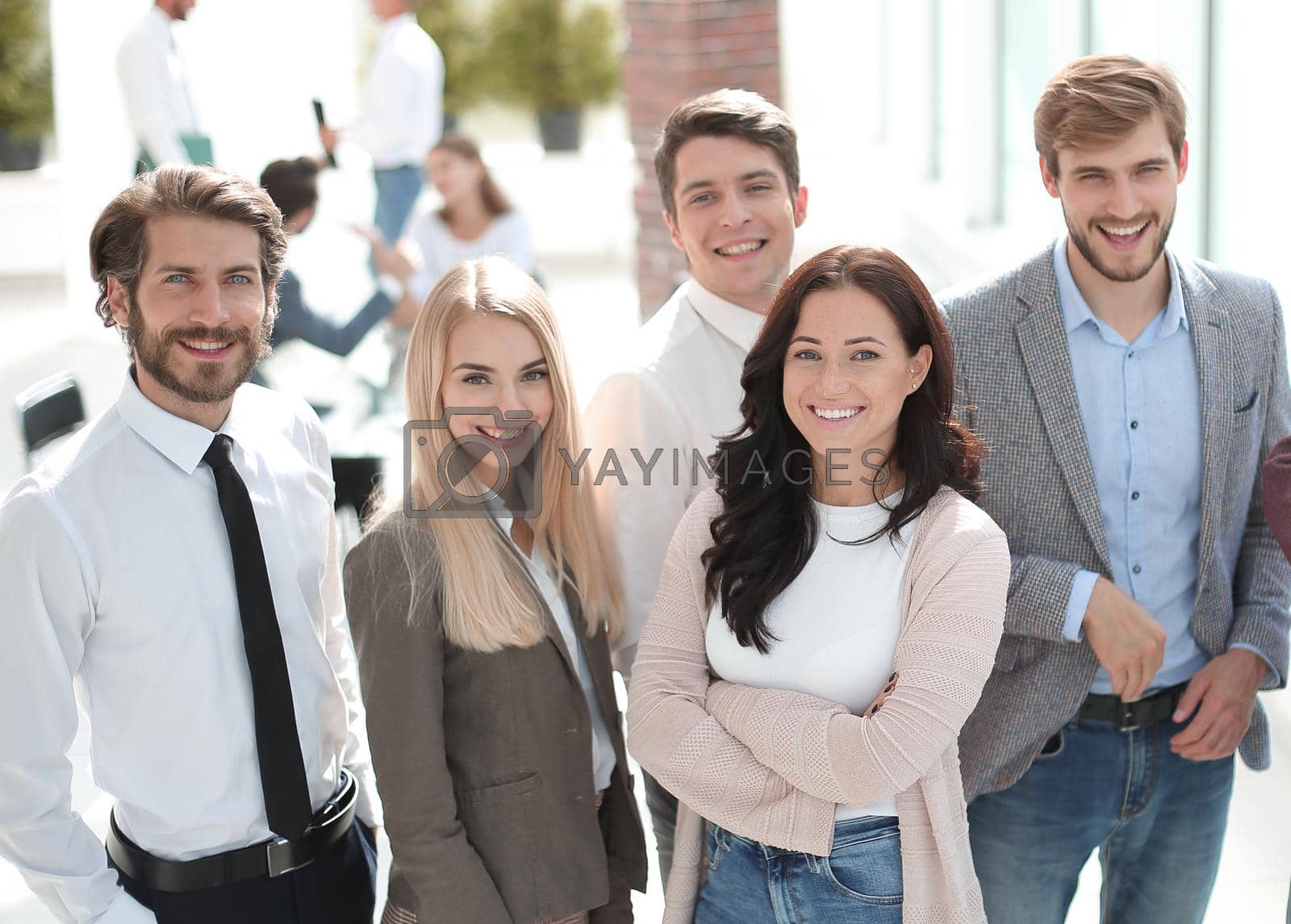Royalty free image of team of successful young employees standing in the office by asdf