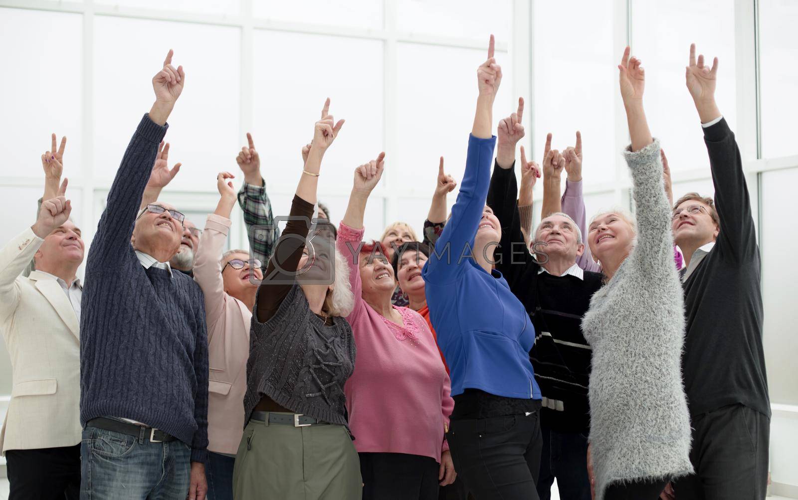 Royalty free image of a group of elderly people are reaching up by asdf