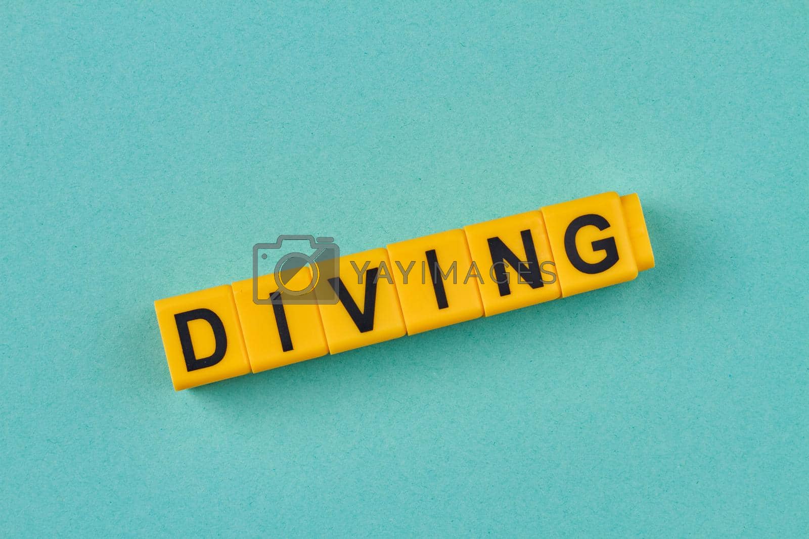 Royalty free image of The word diving written on yellow cubes close up. by super_picture