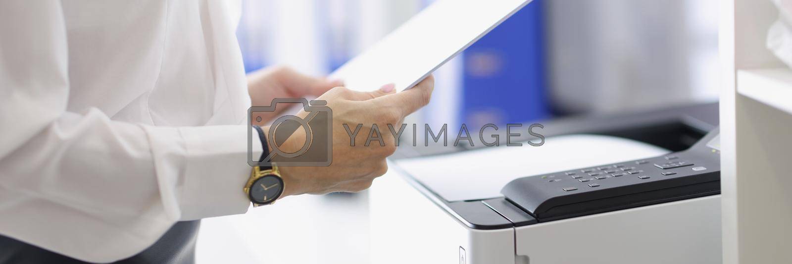 Royalty free image of Woman working with papers in office by kuprevich