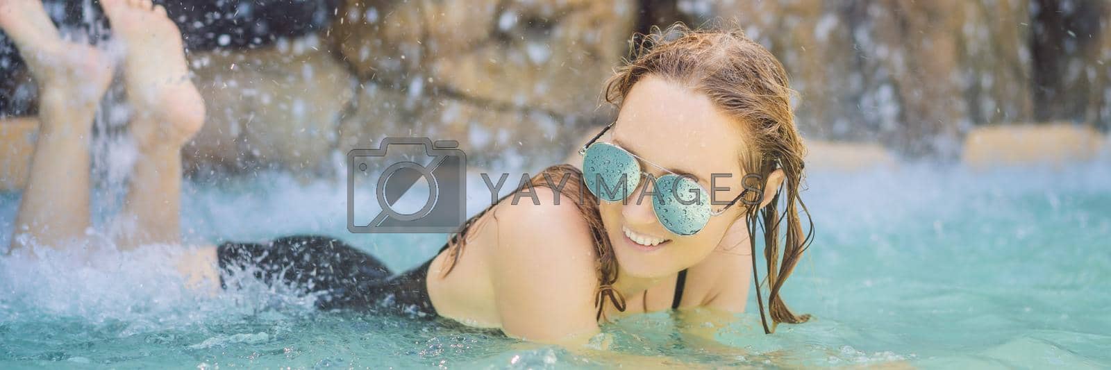 Royalty free image of Young joyful woman under the water stream, pool, day spa, hot springs BANNER, LONG FORMAT by galitskaya