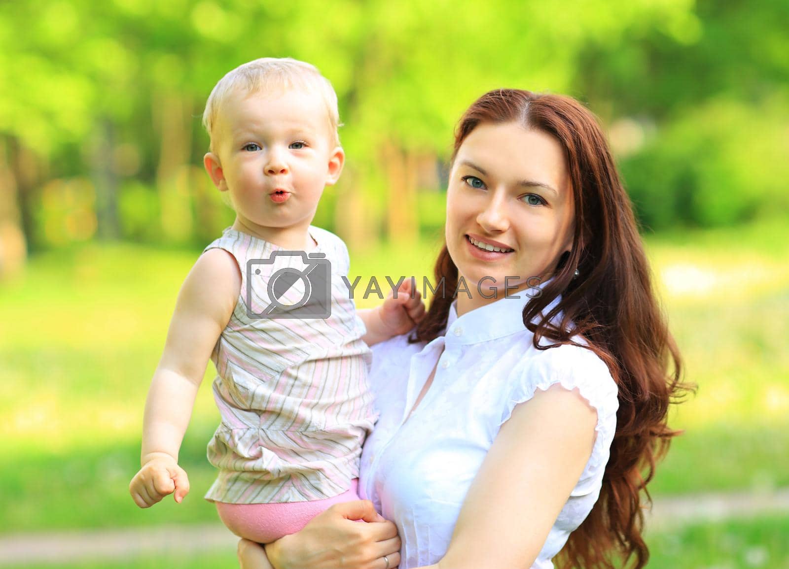 Royalty free image of Happy mother and daughter laughing together outdoors by SmartPhotoLab