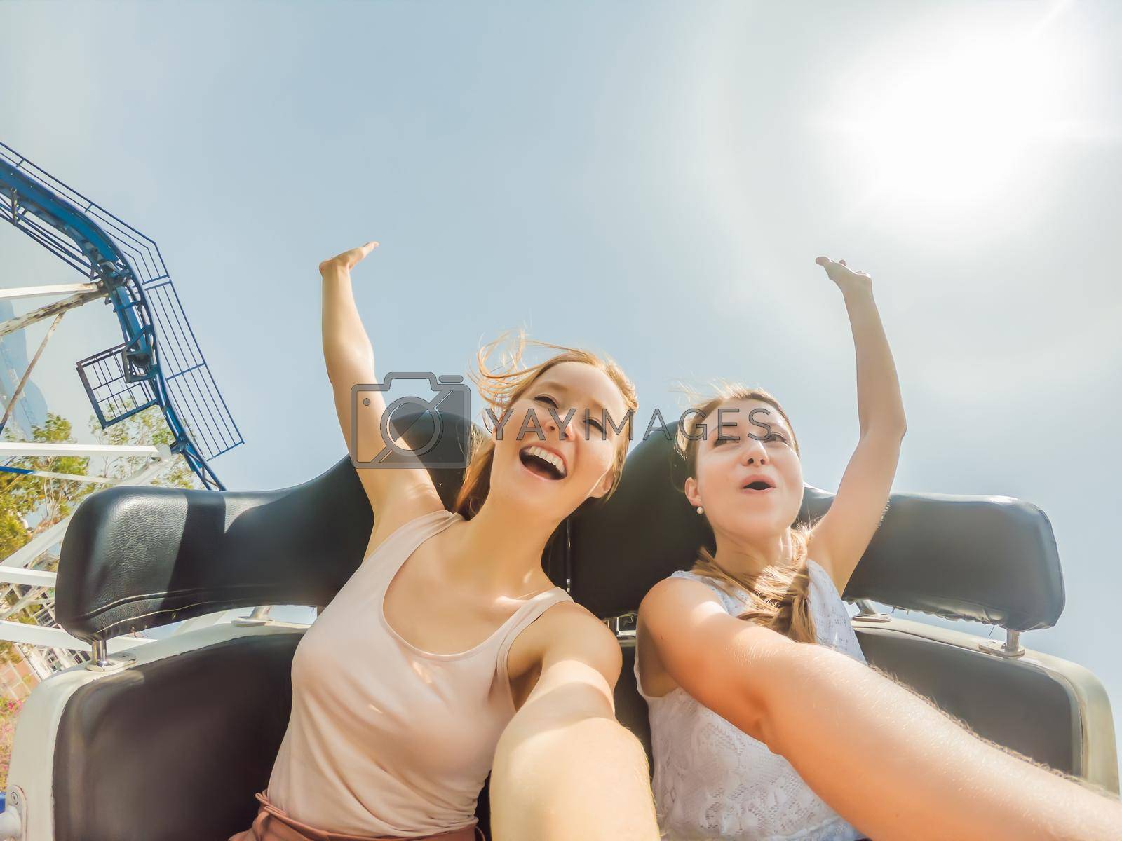 Royalty free image of Two happy girls having fun on rollercoaster by galitskaya
