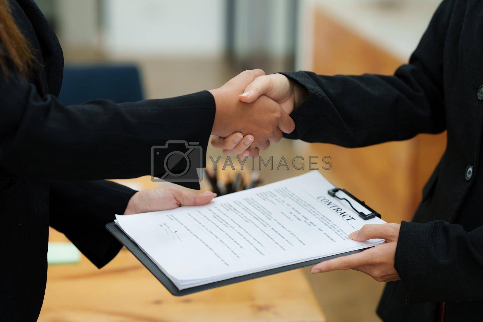 Royalty free image of Real Estate Agent explain insurance and agreement contract to client before sign contract. by itchaznong