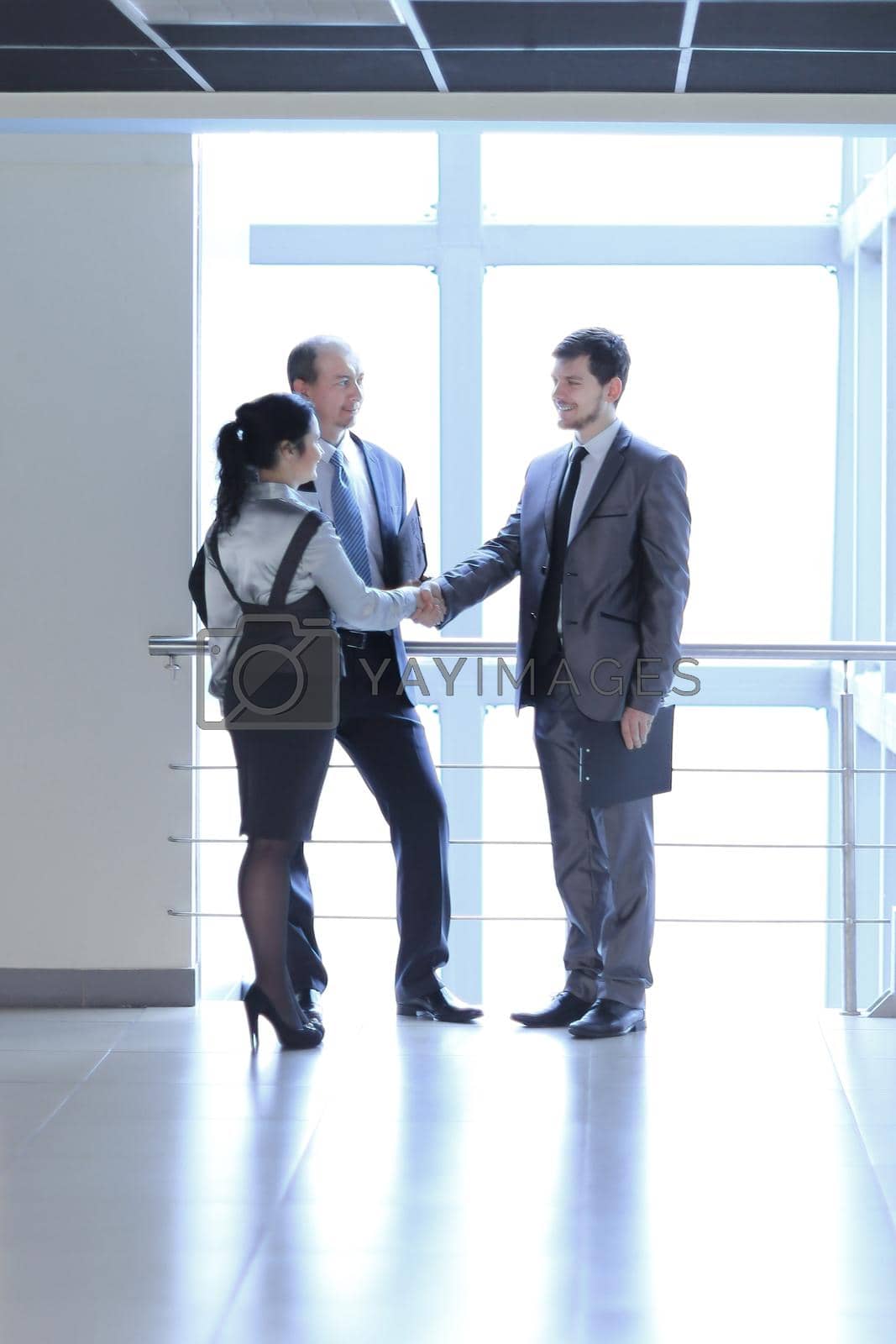 Royalty free image of Manager welcomes the client in the lobby office by SmartPhotoLab
